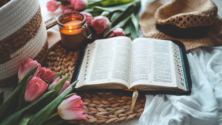 An open Bible with spring flowers; Getty Images