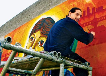 Fabian Debora paints a mural.