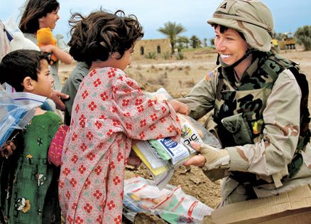 Suzanne Fournier giving  Christmas gifts to children