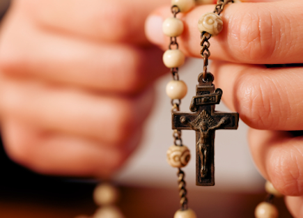 Hands holding a rosary