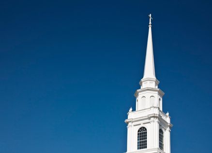 White steeple against blue sky