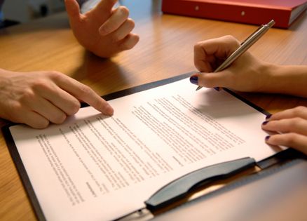 Closeup of woman's hands signing a contract