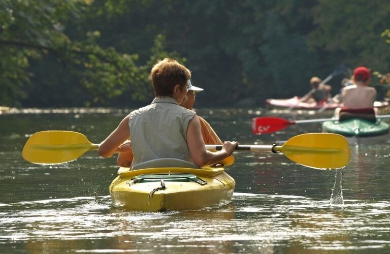 a couple kayaking on a beautiful river