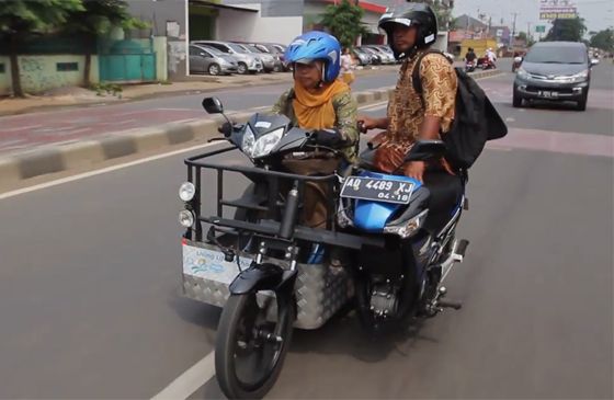 Paraplegic Sri Lestari and her brother ride in a specially designed motorcycle.