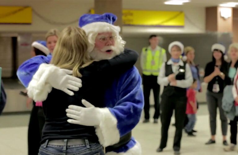 WestJet's Santa hugs a grateful traveler.