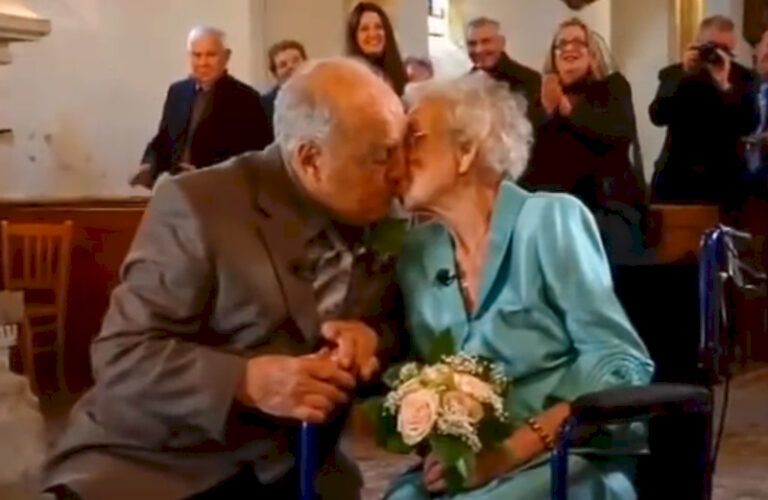 Couple kiss while renewing wedding vows.