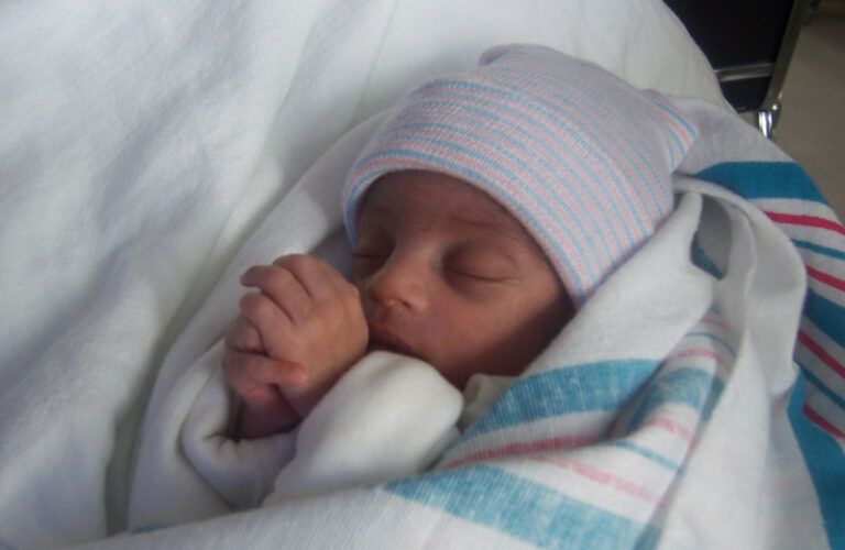 Crystal Clark-Archer's son, Izaiah, with his hands together as in prayer.