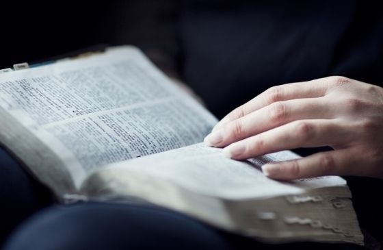 hand resting on Bible