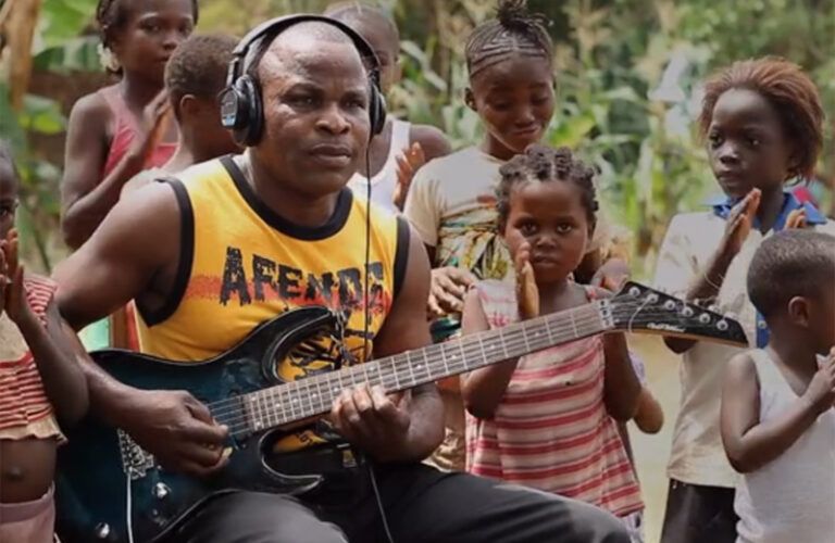 A guitarist in Africa takes part in a recording of "La Bamba."