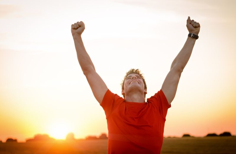 Man with arms lifted in triumph