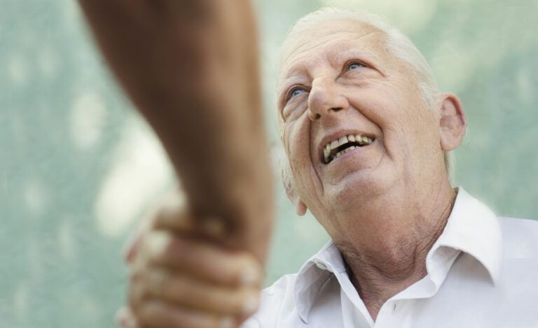 A home health aide at the doorstep of someone's home.