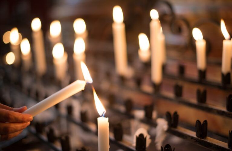 Lighting a candle in church as a gesture of thanksgiving