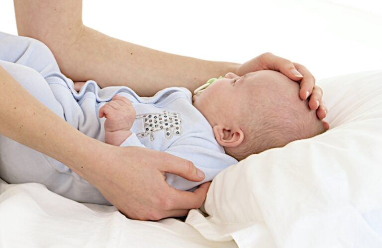 a mother comforting a sick infant