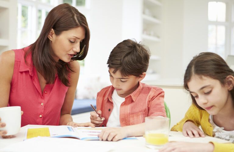 A mother homeschools her son and daughter.