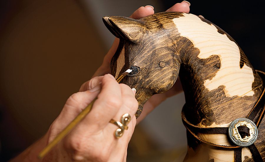 Jackie works meticulously in her studio on one of her equine creations.