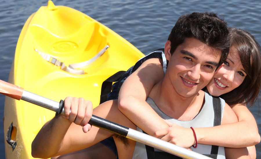 Teen boy and girl in a boat.