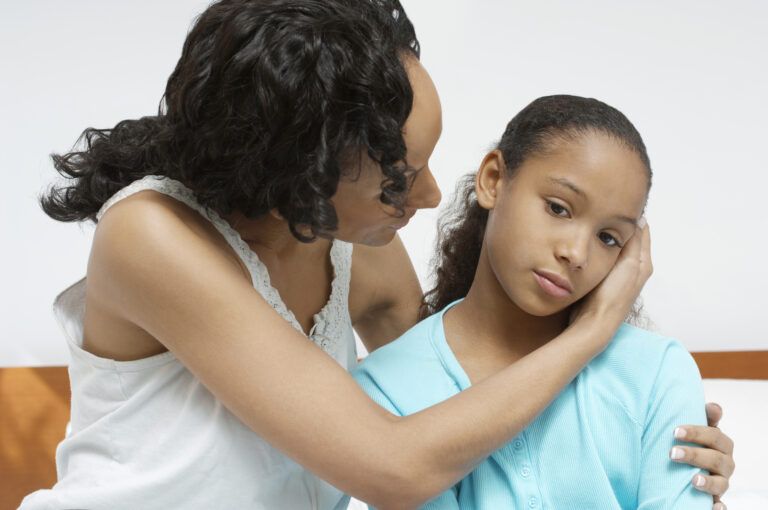 A mother holds her sick daughter