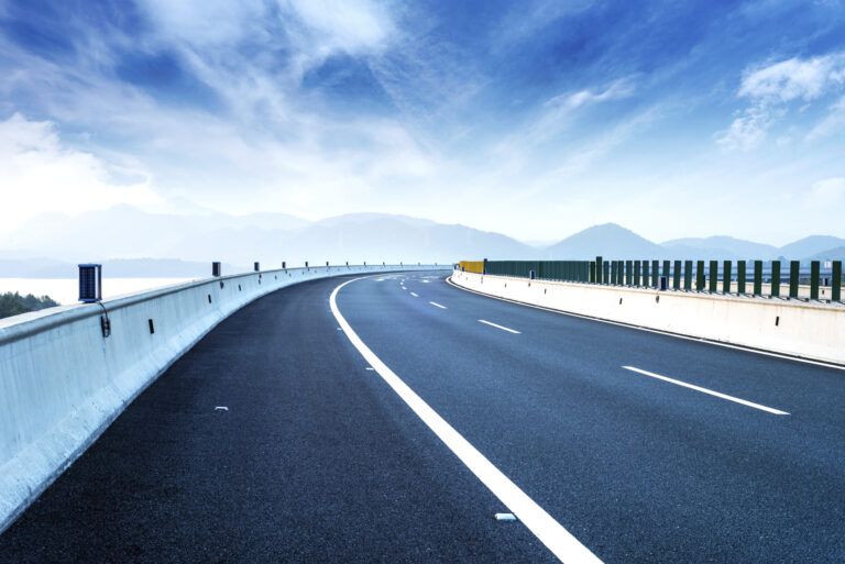 winding freeway with blue sky overhead