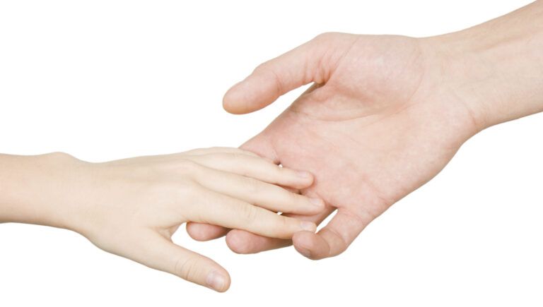 Parent holding a child's hand. Thinkstock.