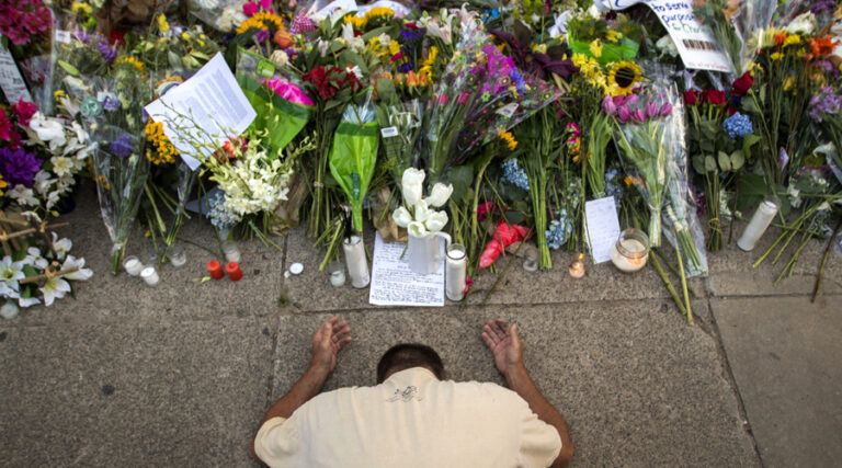 Raymond Smith of Charleston kneels in prayer the front of the Emanuel AME Church before a worship service, Sunday, June 21, 2015, in Charleston, S.C.