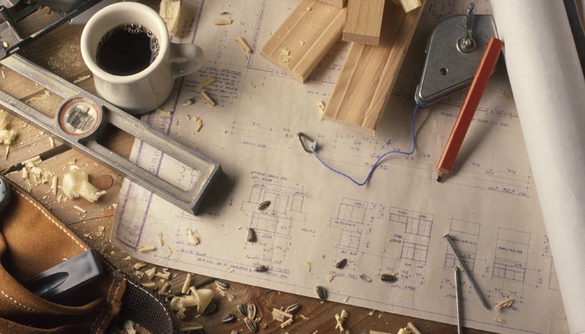 An assortment of construction tools surrounded by sawdust