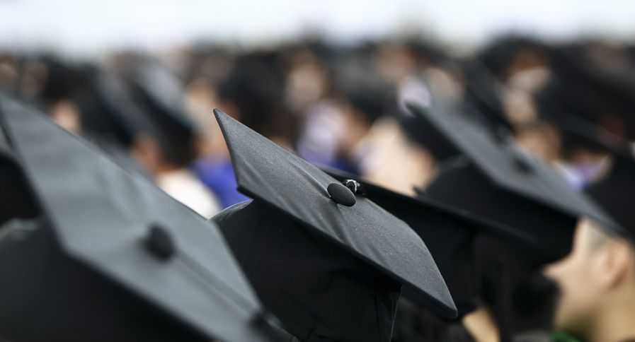 A crowd of graduates at a commencement ceremony