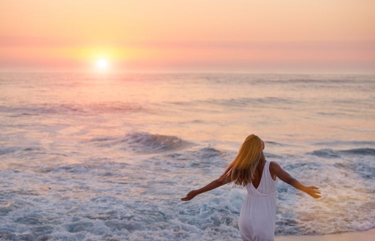 A woman worshipping and praising God while enjoying a vacation