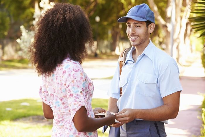 Woman thanking her mailman for Be an Angel Day