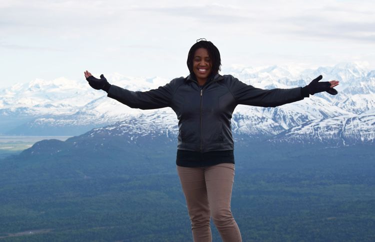 Senior Digital Editor Brooke Obie stands atop a plateau in the Tordrillo Mountain Range near Winterlake Lodge in Alaska