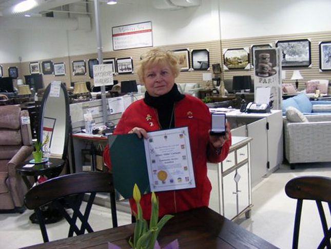 Guideposts: Hillary poses in the furniture store where she encountered George and Joyce Emmerson