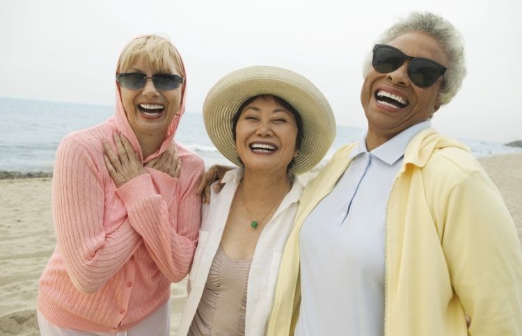 three friends walking on the beach