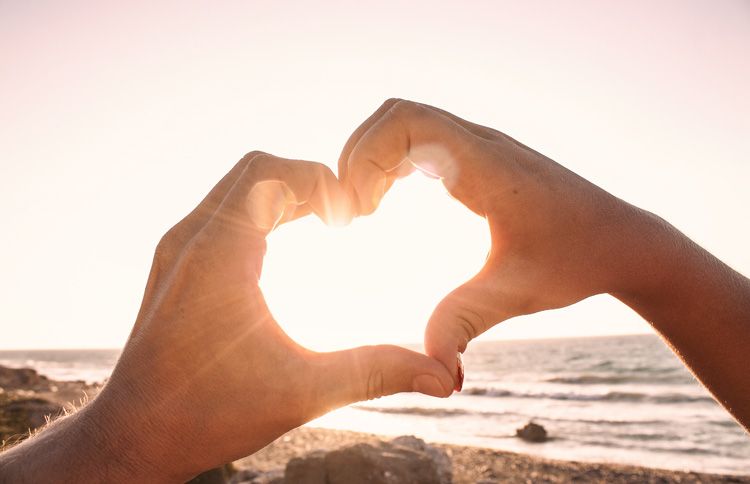 Hands making heart shape with a new year bible verse