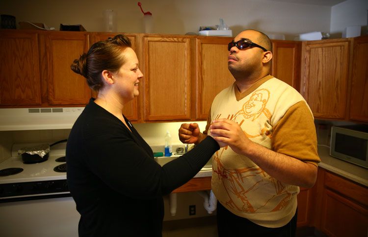 Guideposts: Willie reads sign language by holding an interpreter's hand as she signs.