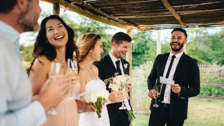 The best man giving a wedding blessing to a newlywed couple