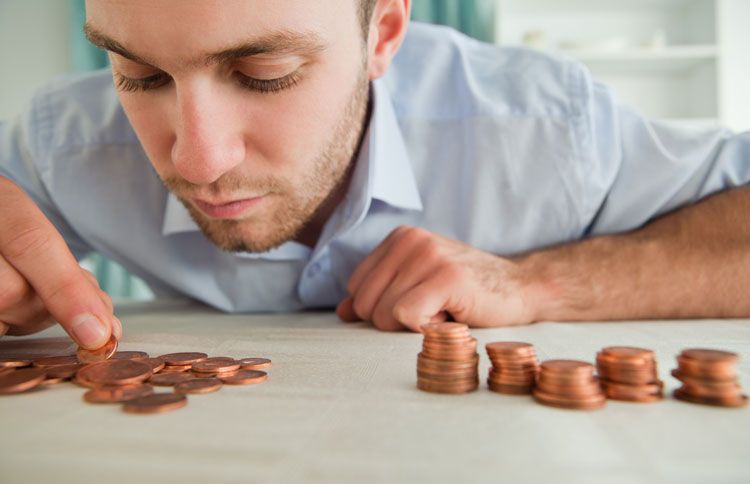 A young man counts his coins