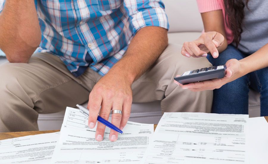 A young married couple works together on their finances