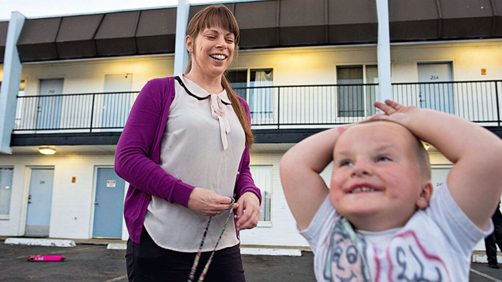 Marsha Carey, the interim project manager of Denver’s Family Motel, with one of the children staying there