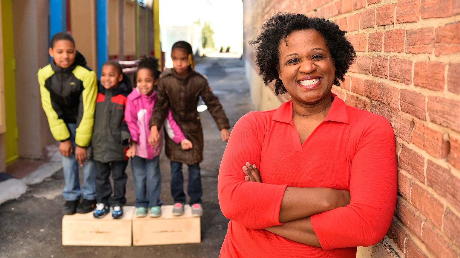 Danita smiles for the camera while her children look on.