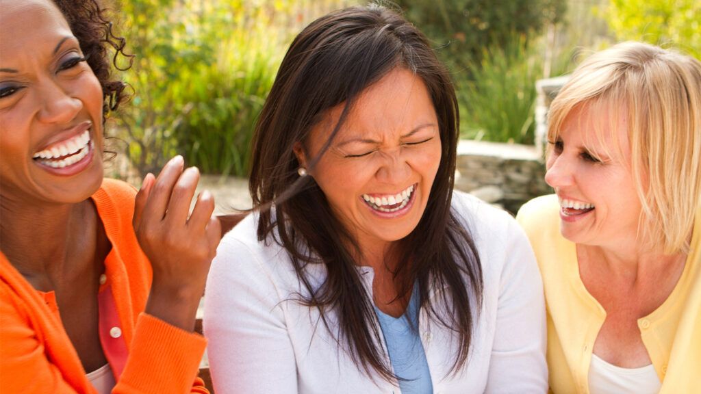 Three women enjoying a good laugh together