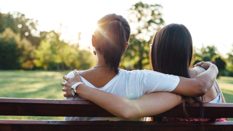 A mother bears sadness as she cares for her daughter.