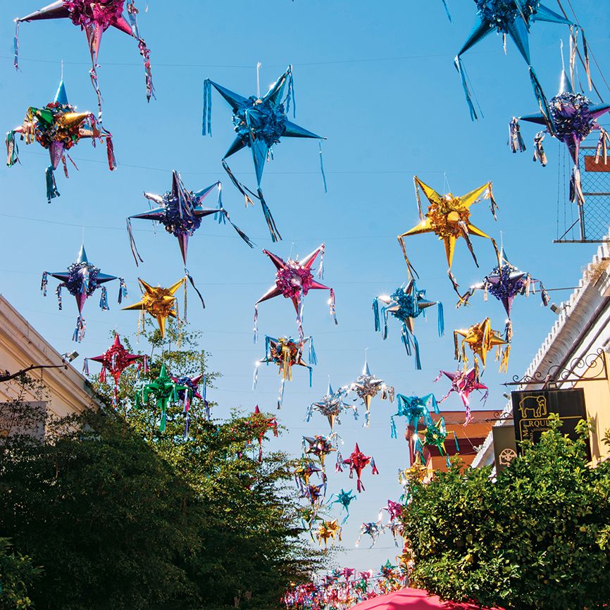 A field of colorful posadas hang from on high