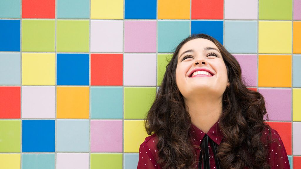 A smiling woman gazes upward; Getty Images