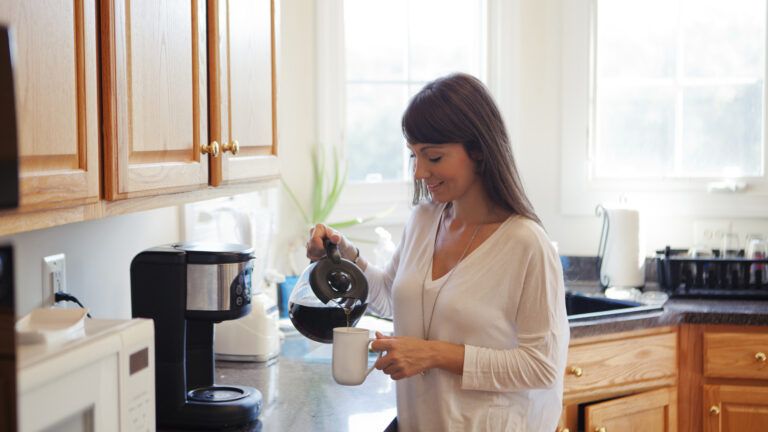 Woman in the kitchen making coffee.