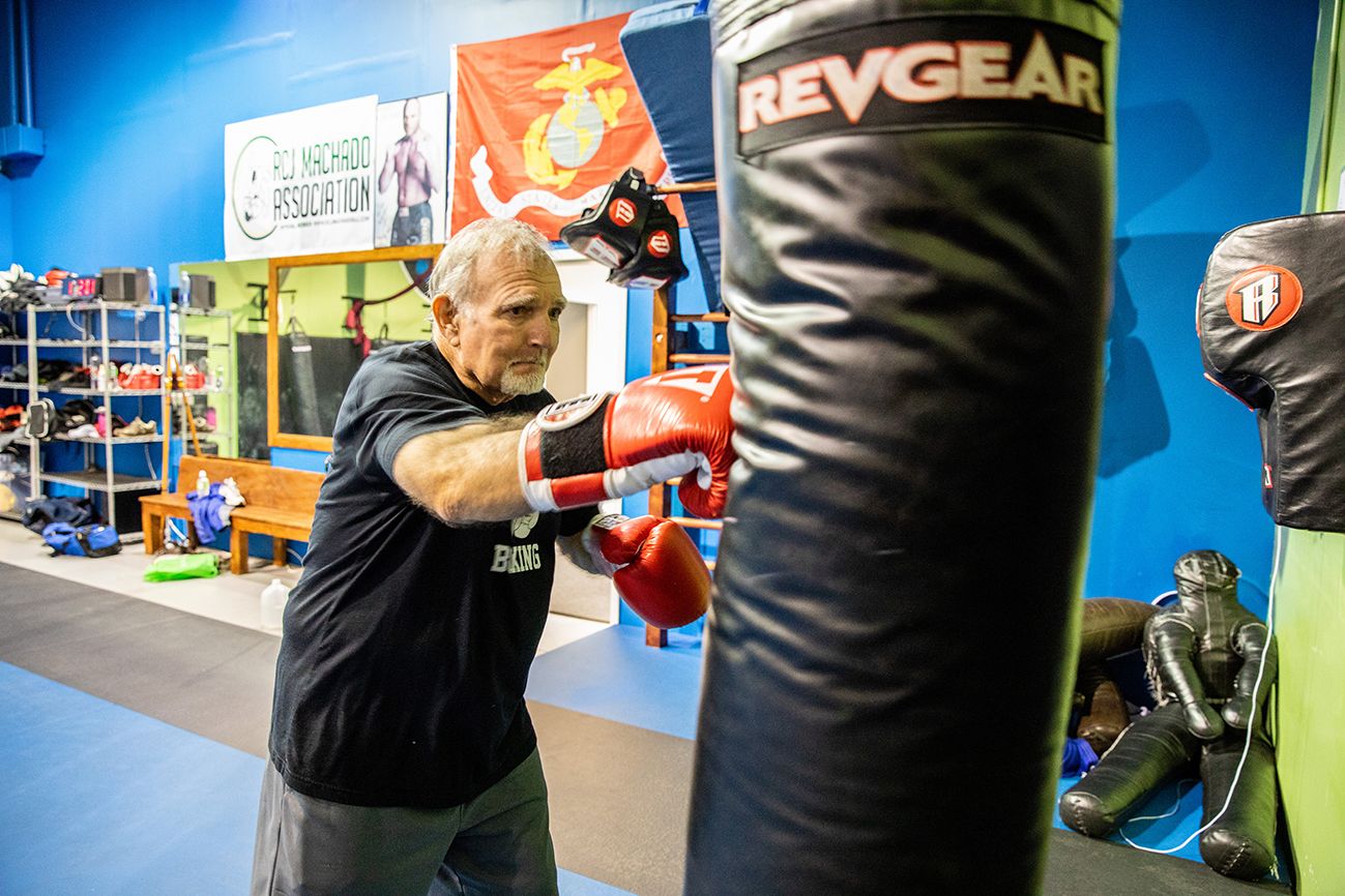 Emmett punches a heavy bag