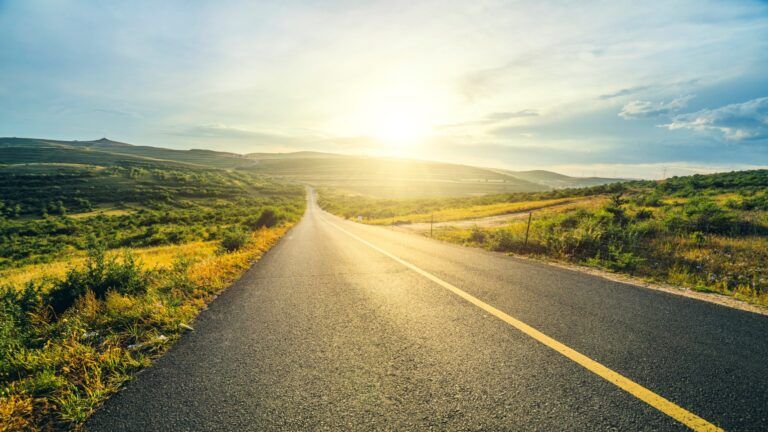 Highway path leading into sunlight; Getty Images