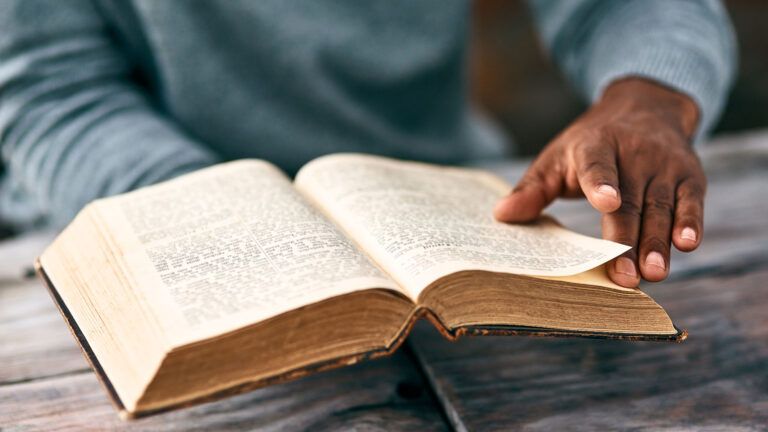 A man holds an open Bible