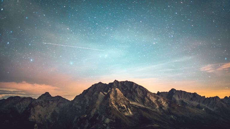 A mountain peak against a starlit sky