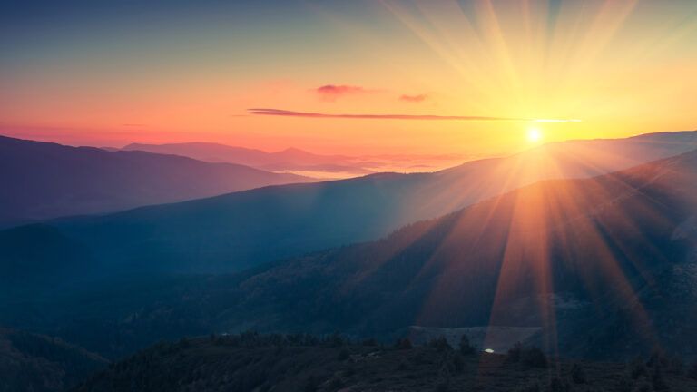 The sun rises over mountaintops