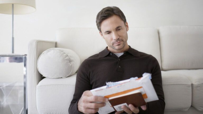 A man sorting and organizing his mail.