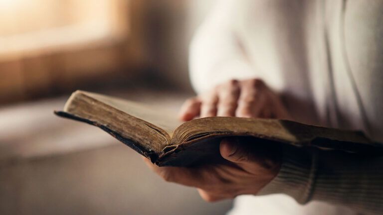 A woman holding a Bible